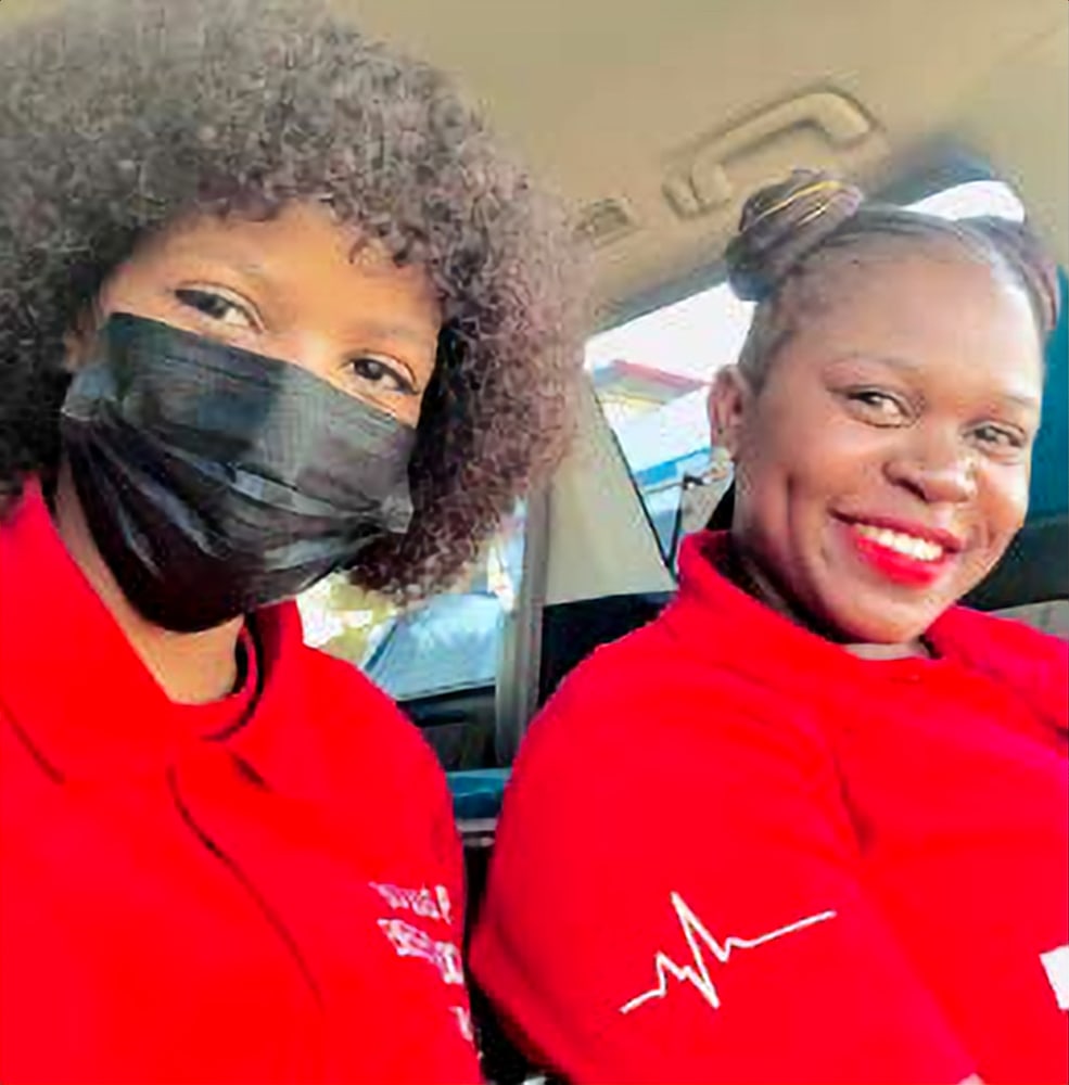 Two smiling Botsogo Pele EMS crew members
